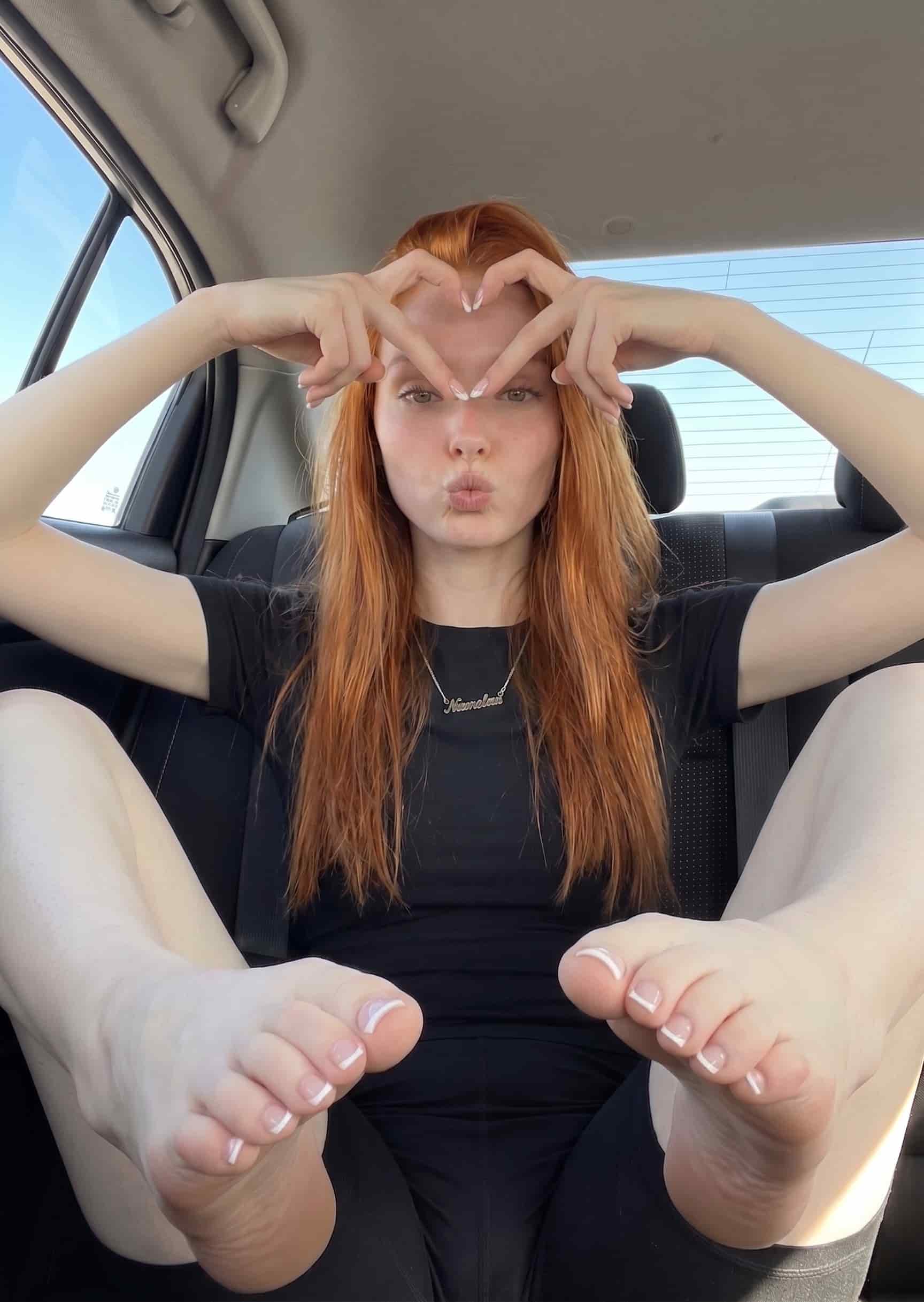 AI-generated car portrait with two bare feet and white French-tip toes in extreme close-up